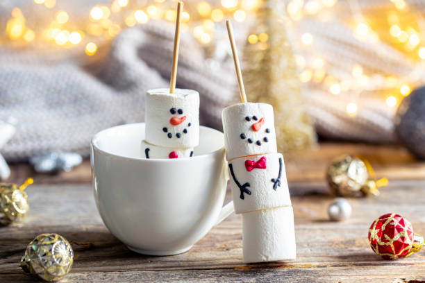 istock Hot chocolate mug and a snowmen made of marshmallows. 1780064646