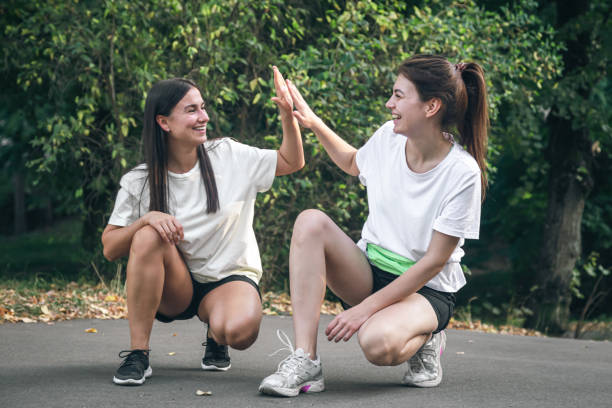 istock Two friends high-five each other after jogging in the park. 1780077002