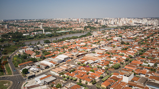 Panoramic aerial view of the city of the municipal dam and the Preto River in the city of Sao Jose do Rio Preto on a sunny day, with houses and tourist attractions of the city in the foreground