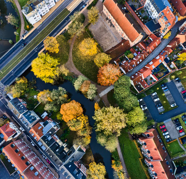 Old residential district downtown Odense Autumn in Odense city. Trees along the stream "Odense Aa" are taking the autumn leaf color. Aerial view at dawn danish culture stock pictures, royalty-free photos & images