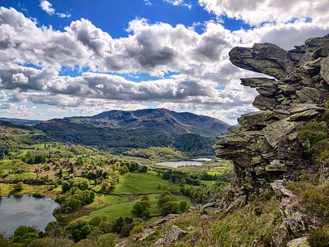 The view of a green countryside from Loughrigg Fell hiking route in Lake District, Cumbria, England