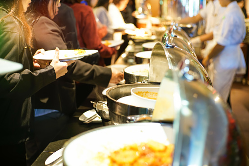 People group grab buffet food in restaurant after seminar