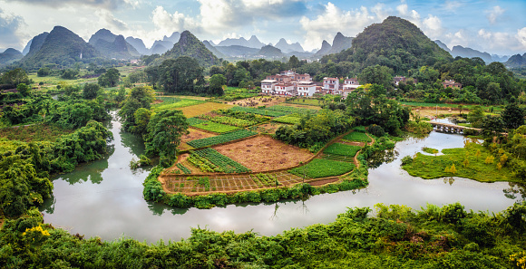 Aerial view of Guilin hills from Cuiping Mountain. Beautiful landscape in Yangshuo county, China as the Li River snakes through the land.