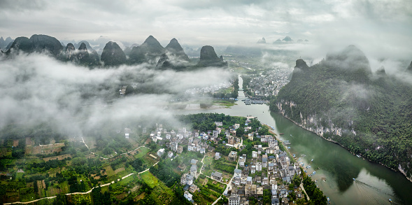 Panorama aerial view of Xingping Ancient Town and Li Jiang river in a cloudy morning. Yangshuo county, Guilin, Guangxi province, China