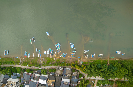Aerial top view of moore ships along the river. aerial view of Li River floating boats and Karst mountains. Located near The Ancient Town of Xingping, Yangshuo County, Guilin City, Guangxi Province, China