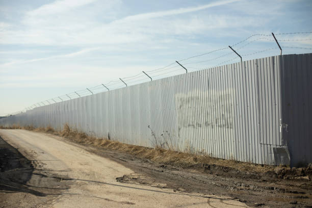 istock Fence in industrial zone. Road along territory. Passage between fences. 1780118002