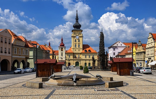 Žatec, Czech Republic, June 11, 2023: View of the main square in this Bohemian town with the fountain and the town hall in the background on a sunny spring day.