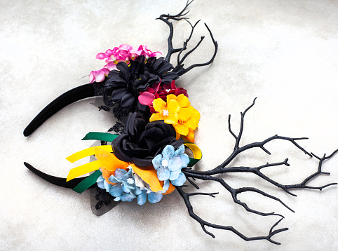 Mystical woodland themed antler headdress with dark antlers and colorful floral décor