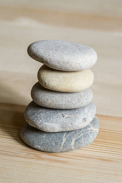 istock Five spa zen stones stacked on a wood background 178012844