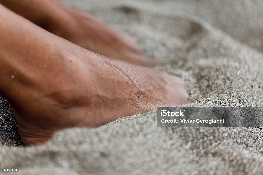 summer memories dry and tanned feet under the sand Abstract Stock Photo