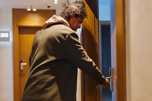 Close-up of a multiracial man coming into his hotel room