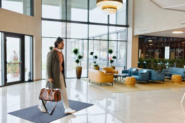 Modern Latin man entering into luxury hotel