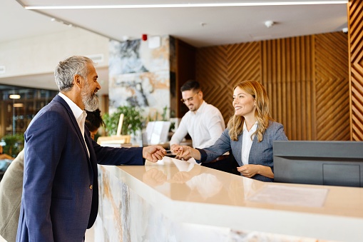 Male and female receptionist working in the luxury hotel