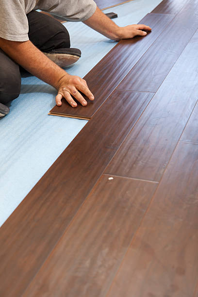 istock Man Installing New Laminate Wood Flooring 178014343