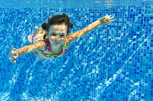 istock Happy active underwater child swims in pool 178014503