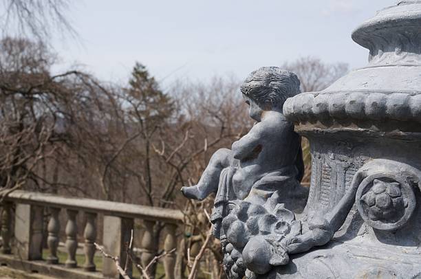 istock Cherub overlooks a formal garden 178014768