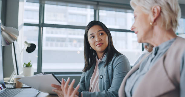 istock Business women, conversation and teamwork in office, training planning and management with paperwork. Files, discussion and employees consulting, manager collaboration and communication for report 1780158508