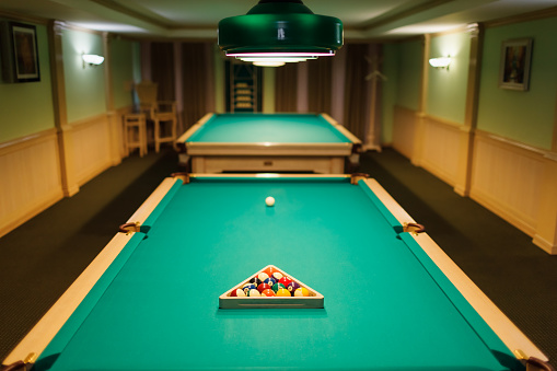 Billiard accessories balls and cue on a billiard table room