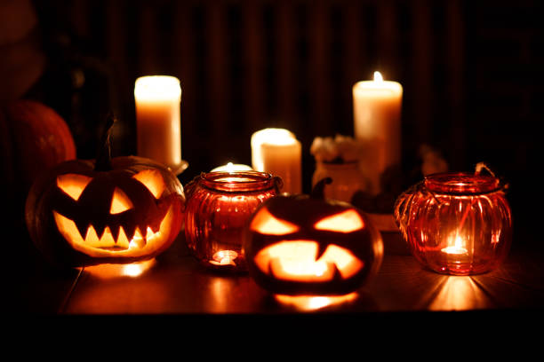 istock Making Halloween pumpkin Jack-o-lantern. Pumkins and candles on table 1780168143