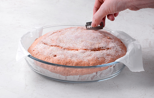 Proofing tomato sourdough bread and making cuts with razor blade for good shape