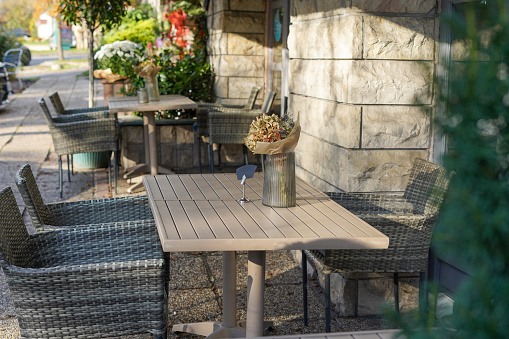 Cozy outdoor cafe with sunlights and dried flowers on the table