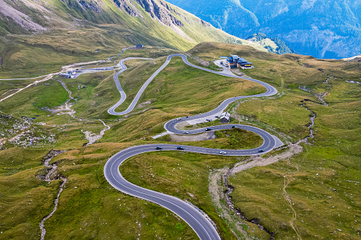 Beautiful view of the famous Austrian seršentine road Grossglockner Hochalpenstrasse. Aerial view of scenic Grossglockner High Alpine Road route in Austria with mountains and clouds in summer