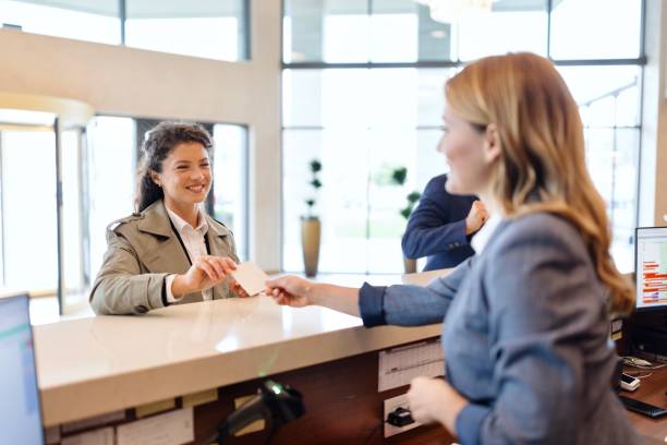 istock Woman taking her cardkey at the hotel reception 1780196905