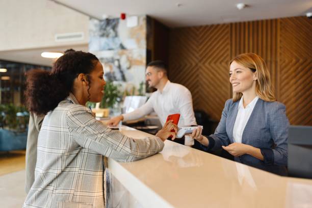 istock Guests paying with different devices at the receptions in the hotel 1780196992