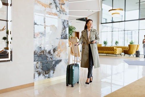 Beautiful business woman walking around a luxury hotel