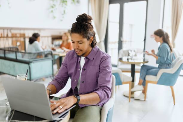 istock Latin man typing something on his laptop at the luxury hotel 1780197580