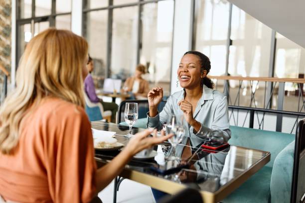 istock Beautiful female colleagues sitting at the caffe and talking about something 1780198136