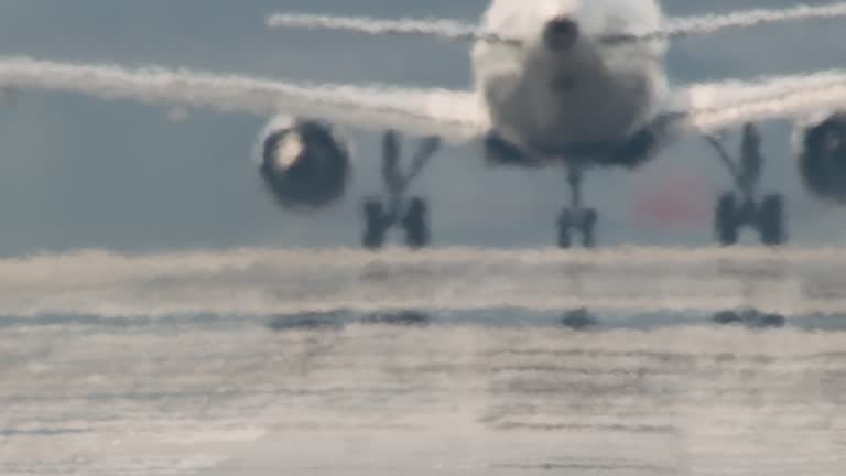 Close-up of Back of Airplane Taxiing Down Runway and Taking Off