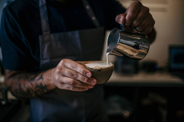 istock Artistic barista crafting latte art on a sleek coffee machine 1780199867