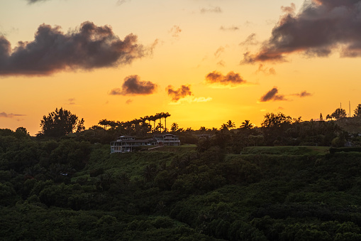 Orange sunset view of ridge near Kilauea, Kauai, Hawaii, United States.