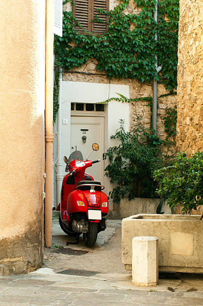 istock Small scooter parked at the old quarter buildings 178020434