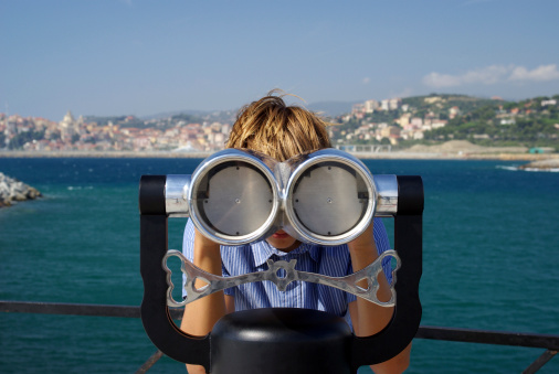 Boy looking through a telescope