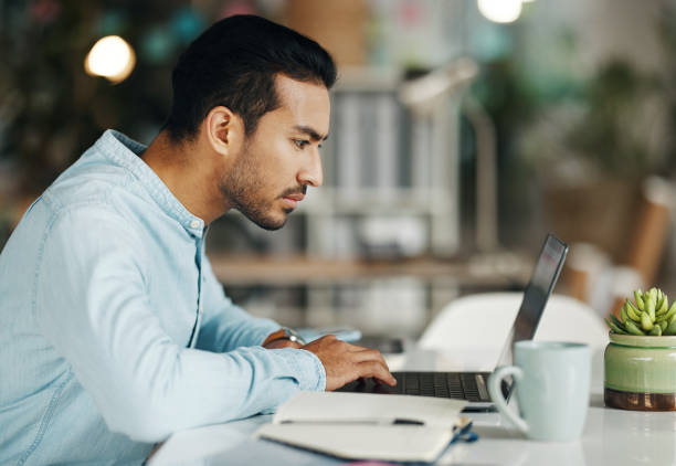 istock Business, focus and man with laptop, research and online reading in workplace, software update or website design. Male employee, consultant or worker with device, technology or typing with connection 1780208202