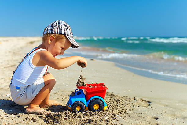 istock cute baby boy playing on the beach 178021304