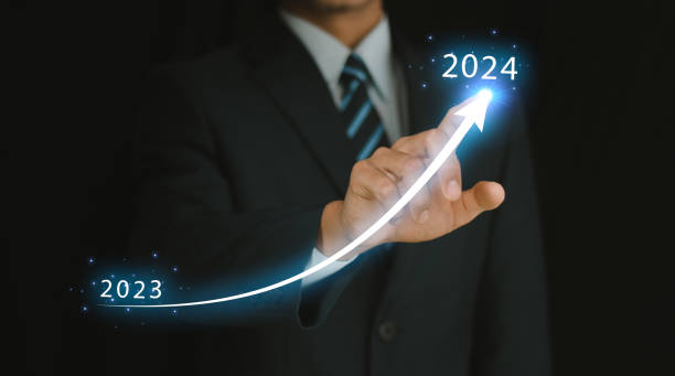 New years 2024 start up investment new business and finance. Businessman hand pointing graph on target 2024. Stock market, Business growth, progress or succe New years 2024 start up investment new business and finance. Businessman hand pointing graph on target 2024. Stock market, Business growth, progress or succe compass gear efficiency teamwork stock pictures, royalty-free photos & images