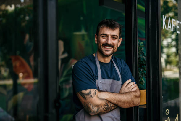 Small business cafe owner welcoming you stock photo