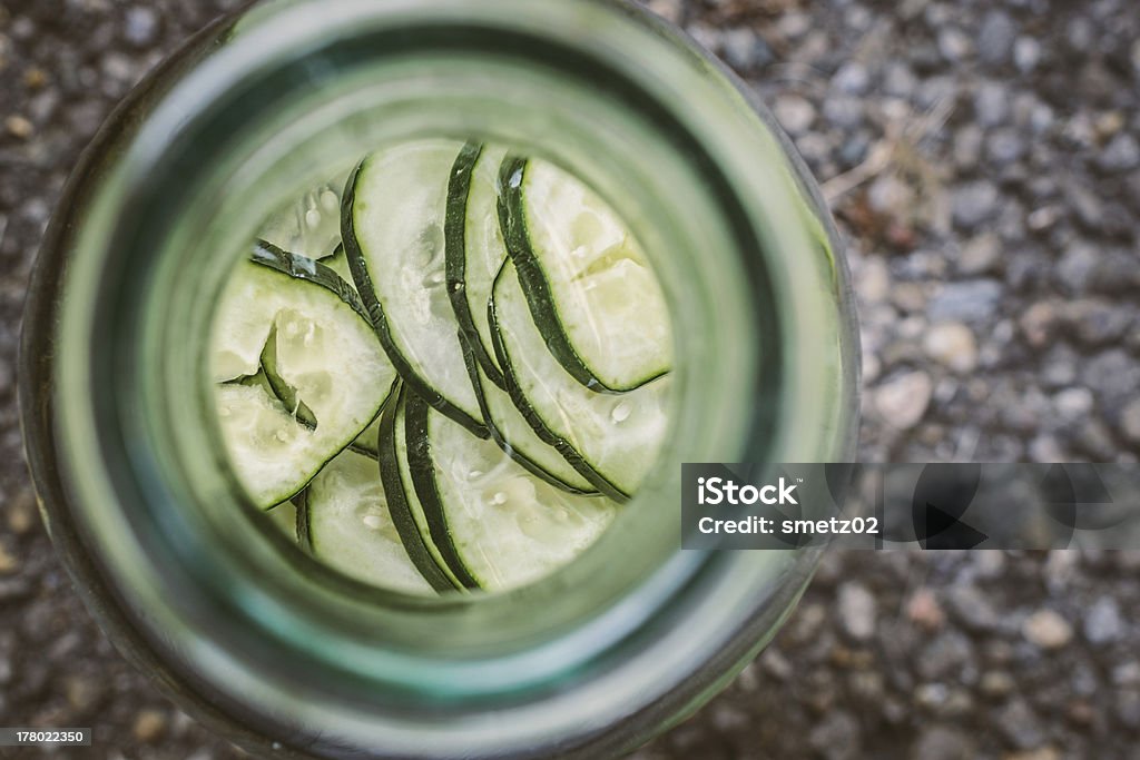 Organic Cucumber Water Unique angle looking down into a carafe of fresh organic cucumber water Bright Stock Photo