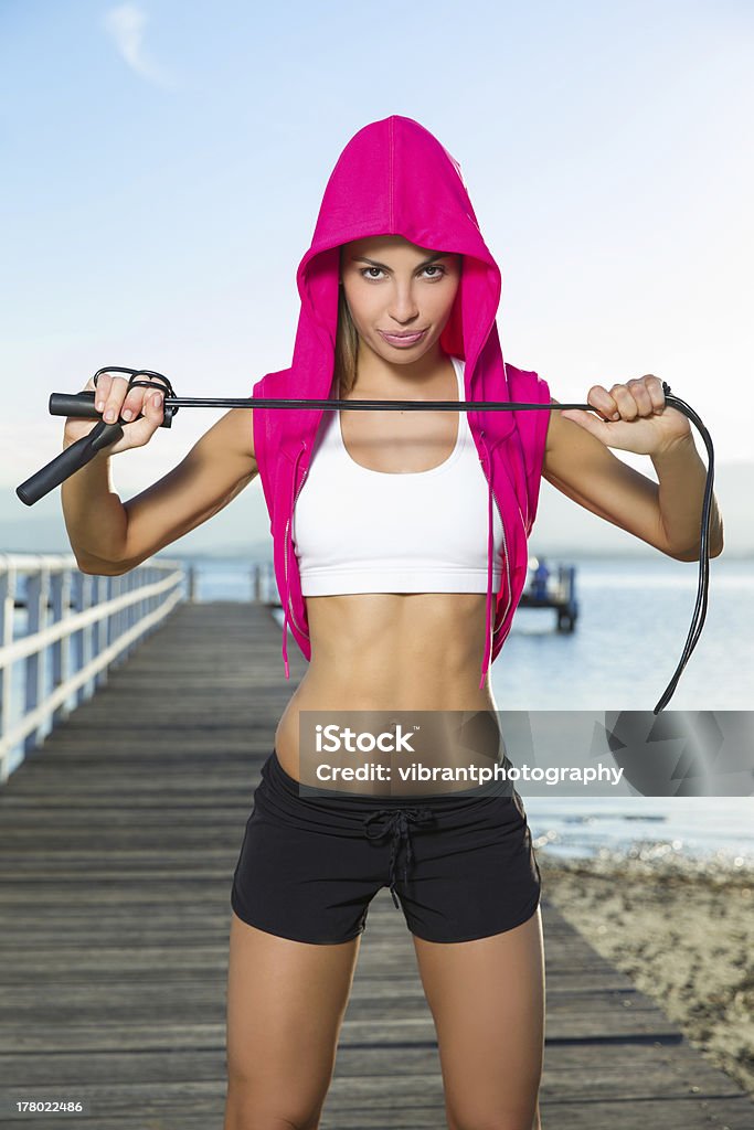 skipping stare Young healthy lady holding skipping rope and looking determined. 20-24 Years Stock Photo