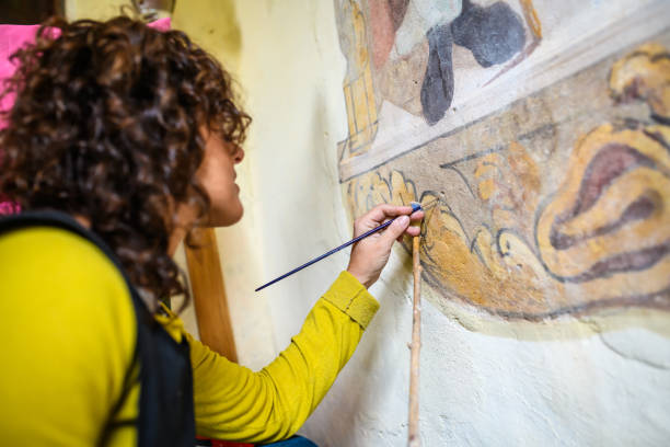 профессиональный реставратор, восстанавливающий фрески античной часовни в италии - restoring painting working church стоковые фото и изображения