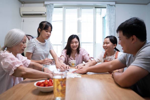 istock The three generations family board game time 1780234595