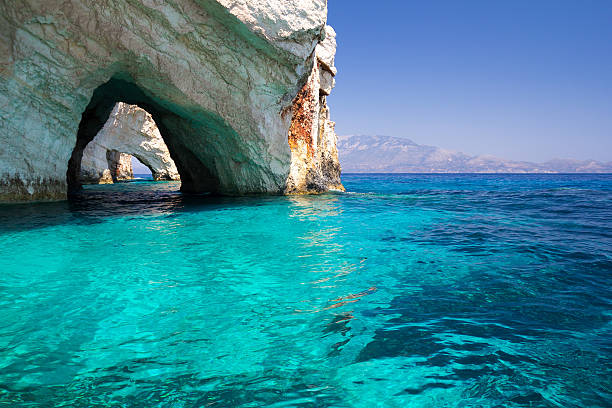 cuevas en mediteranean al mar azul - vibrant color summer rock cliff fotografías e imágenes de stock