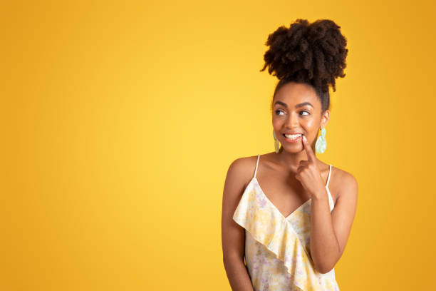 istock Glad pensive millennial black lady thinks, got idea, put finger to lips, flirting 1780242995