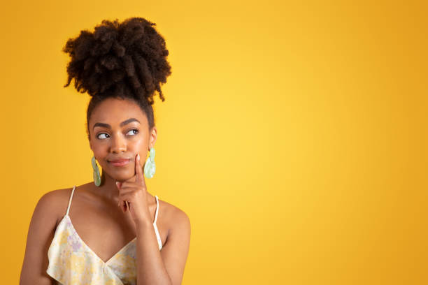istock Pensive glad pretty young black woman thinking, looking at empty space 1780243573