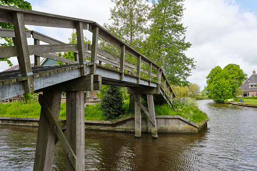 Wooden footbridge for bicycles and pedestrians over the Dokkumer Ee in town of Bartlehiem in Friesland The Netherlands. Made famous during the Eleven Cities skating tour