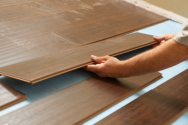 istock Man Installing New Laminate Wood Flooring 178024878