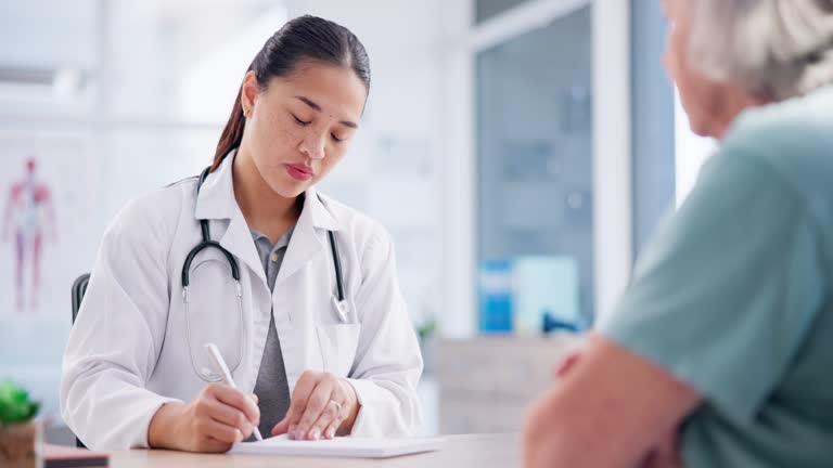 Prescription, consultation and doctor with senior patient writing on paper for medication treatment. Advice, checkup and female healthcare worker talking to an elderly woman in medical clinic office.